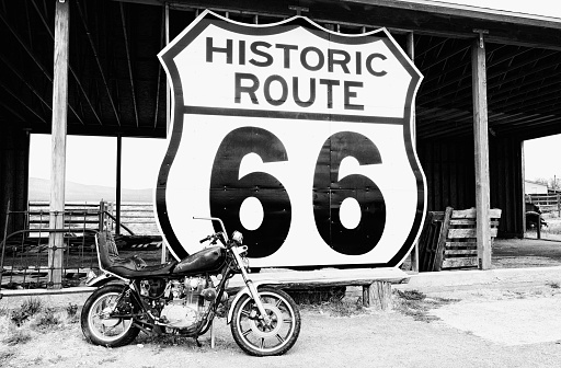 Vintage Motorcycle in front of an abandoned shed, Route 66 near to the vintage Frontier motel, Truxton, Mohave county, Arizona, USA.