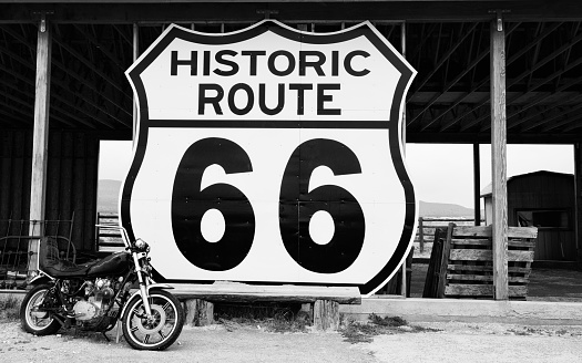 Vintage Motorcycle in front of an abandoned shed, Route 66 near to the vintage Frontier motel, Truxton, Mohave county, Arizona, USA.