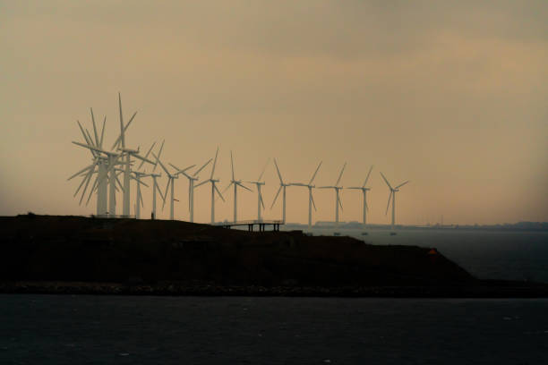 istock Massive offshore wind turbines  generating clean green energy from ocean winds. 1295940632