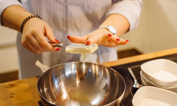 istock Woman hands putting butter in a bowl 1295941089