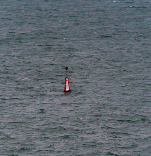 istock Red and white maritime center marker buoy for navigation at sea. 1295941385