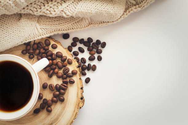 White cup of black hot coffee drink and coffee beans