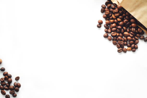 coffee beans are scattered on a white background. coffee in a paper bag. coffee and the environment. top view