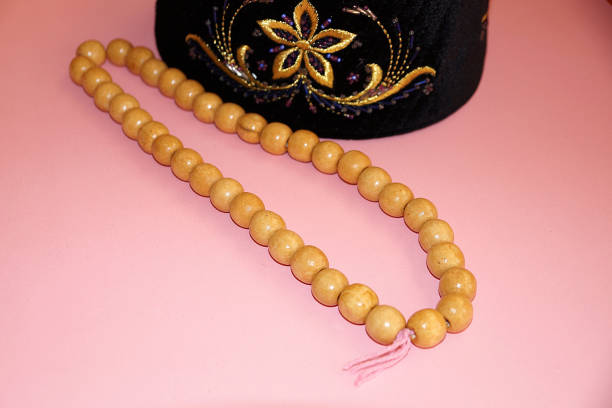istock wooden prayer beads for prayer and embroidered skullcap on pink background 1295945430