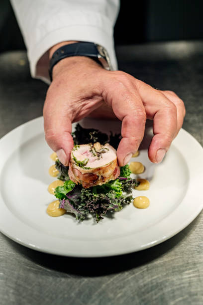 istock Chef adding the final fourish to a meat course of pheasant at the pass. 1295946694