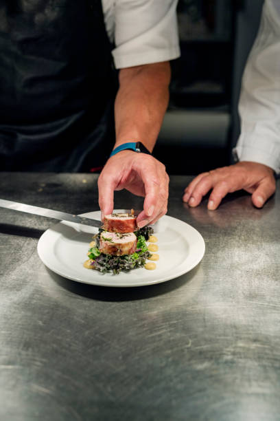 istock Chef adding the final fourish to a meat course of pheasant at the pass. 1295946974