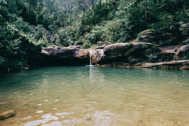 istock landscape with a pool with waterfall in a place of spain 1295947719
