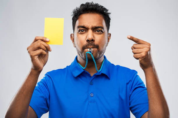 istock indian referee whistling and showing yellow card 1295951263
