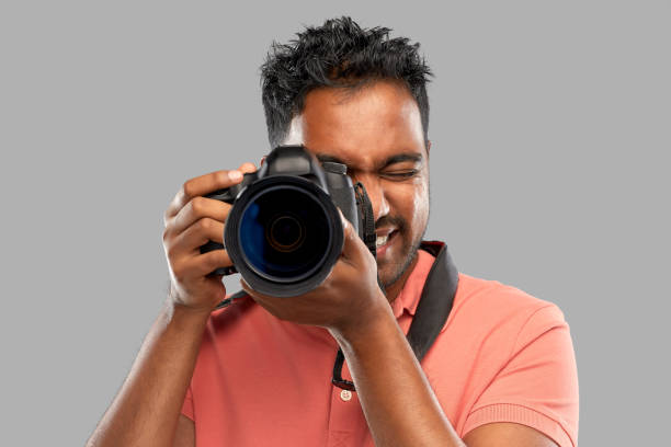 istock indian man or photographer with digital camera 1295951589