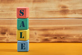 different colored blocks with the wordings SALE, isolated against yellow background
