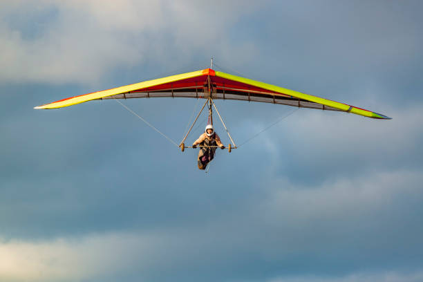 istock Beginner girl pilot withcolorful hang glider wing. 1295954426