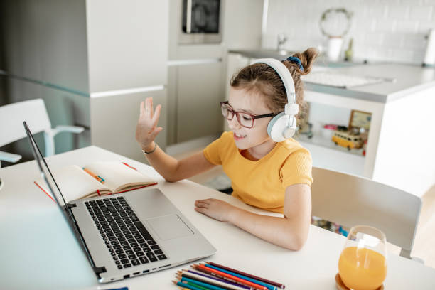 istock A little girl attending online classes at home 1295955310