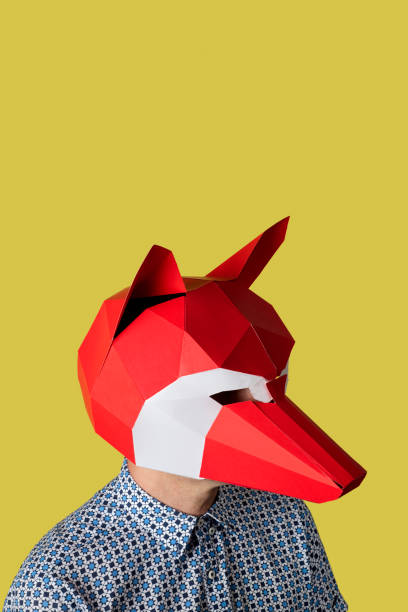 istock man with a red fox mask on a yellow background 1295955845