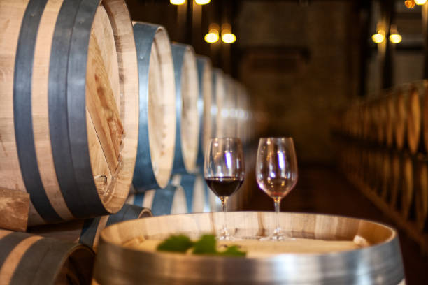 istock Glass of red wine on a wine barrel 1295959990