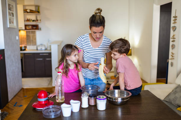 istock Happy family making cake together 1295960347