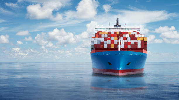 front view from bow of a large blue shipping container ship. - ocean freight imagens e fotografias de stock