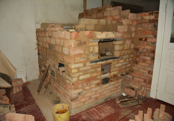 istock Building of a Russian masonry stove, wood fired oven from a red fire brick. 1295962700