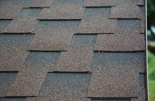istock A close-up a roof covered with copper brown bitumen, asphalt laminated, dimensional, or architectural roofing shingles.  Asphalt shingles background. 1295963232