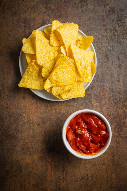 istock Tortilla chips and red tomato salsa dip. Mexican nacho chips. 1295964445