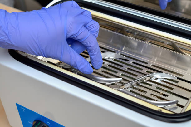 istock Hand in protective medical blue gloves preparing manicure forceps for steam sterilization 1295964791
