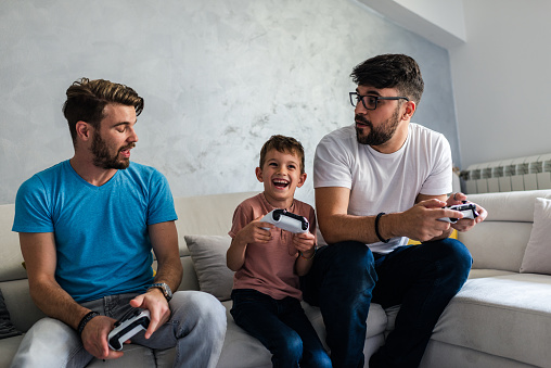 Family screen time. Playing video games and spending time together during COVID-19 isolation.