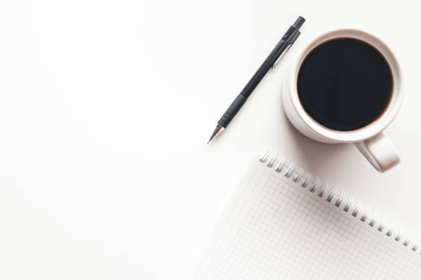 istock Office desk table with supplies, coffee cup and flower. Top view 1295967977