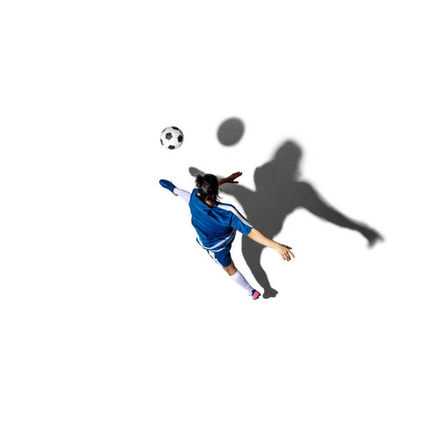 Kicking the ball. Young man soccer football player isolated over white background with shadow. Top view. Concept of action, motion, youth, sport, healthy lifestyle. Copy space for ad, design.