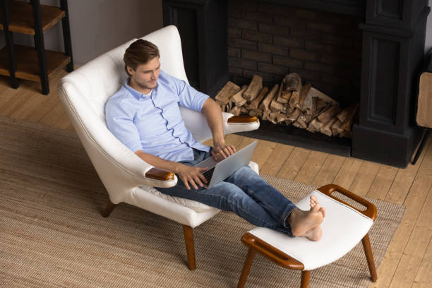 istock Caucasian man relax in chair using laptop 1295970346