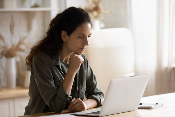 istock Young woman sit at desk working on laptop online 1295970441