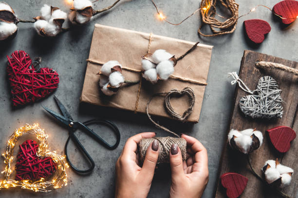 istock Woman preparing gift for wrapping for Valentine's Day 1295970575