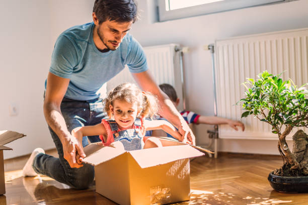 istock Playful family into new home 1295973707