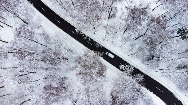 istock Road through wintery landscape - aerial view 1295981178