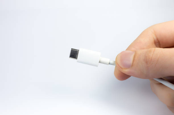 istock Man holding USB Type C Port Cable for charging. Close up photo. 1295981564