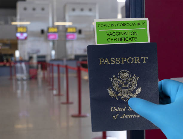 istock Coronavirus vaccination and travel concept. COVID-19 coronavirus vaccination certificate in passport. Border control and quarantine of tourists infected with coronavirus. Ban of flight between countries 1295981849