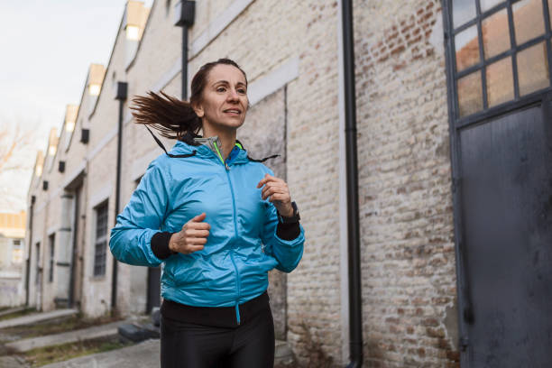 istock Young woman running outdoors in morning time 1295981940