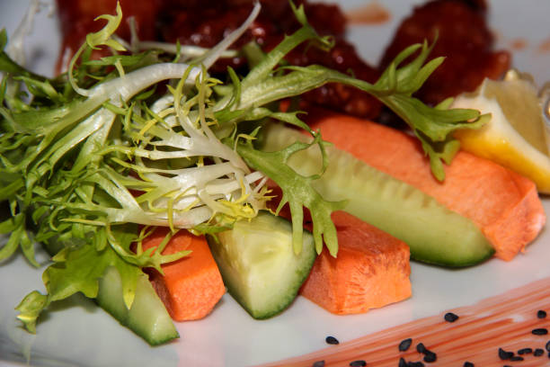 istock Fresh carrots, cucumber, arugula with lemon and meat. 1295982864
