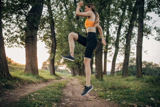 istock Fit woman exercising alone in nature 1295983022