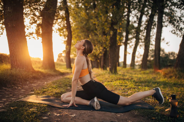 istock Fit woman exercising on exercise mat in nature 1295983402