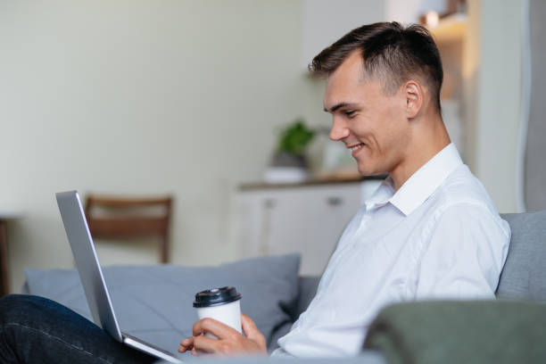 istock young man with a takeaway coffee reading his email 1295984046