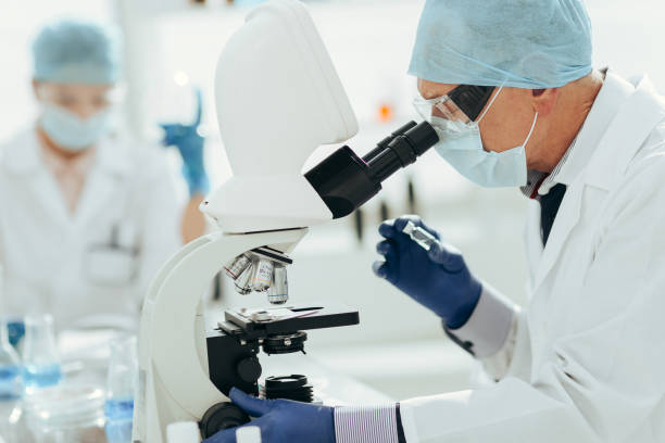 istock ambitious scientist looking at an ampoule with a new drug 1295984379
