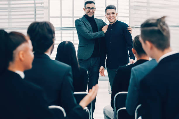 istock project Manager introducing a new employee.business concept 1295984399