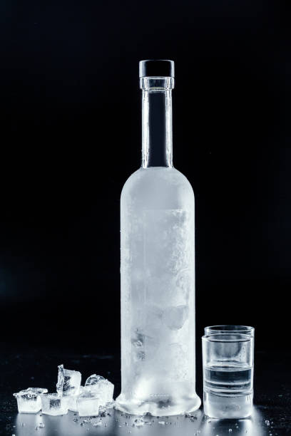 istock Bottle of cold vodka on dark background 1295985566