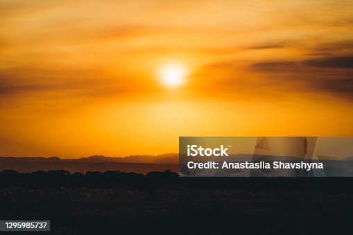 istock Scenic view of burning sunset above the mountains and savannah in Tanzania 1295985737