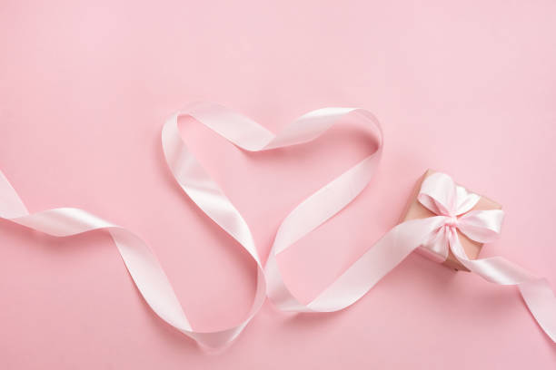 istock Heart from pink ribbon and gift box. Valentine's Day composition. 1295985874