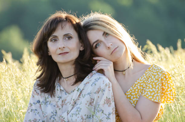 istock Mature mother with her middle age daughter spending time together outdoors summer time 1295986783