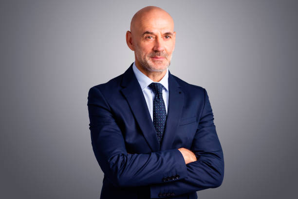 istock Executive senior businessman studio portrait 1295988133