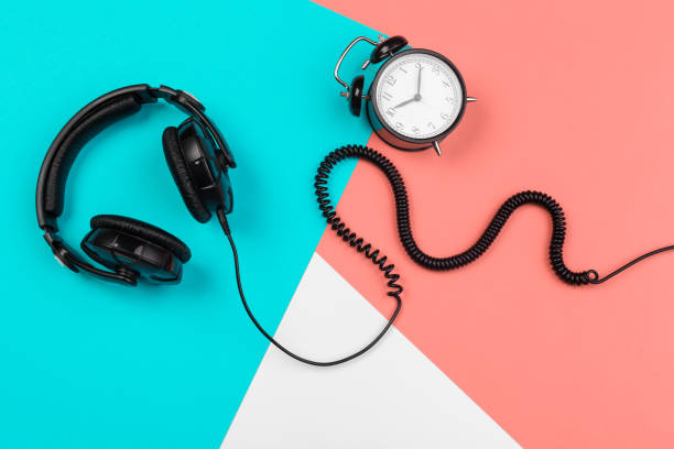 istock Headphones with cord on a bright color block background 1295988157