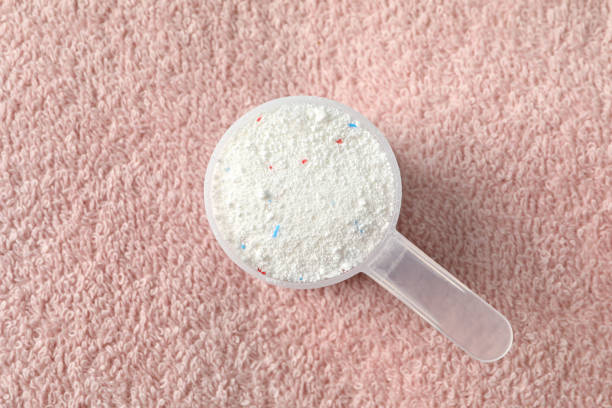 istock Scoop with washing powder on towel background 1295988375