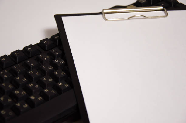 istock keyboard and white sheet lie on a white background 1295988979