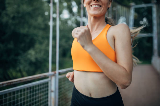 istock Fit woman jogging on a small bridge in nature 1295990608